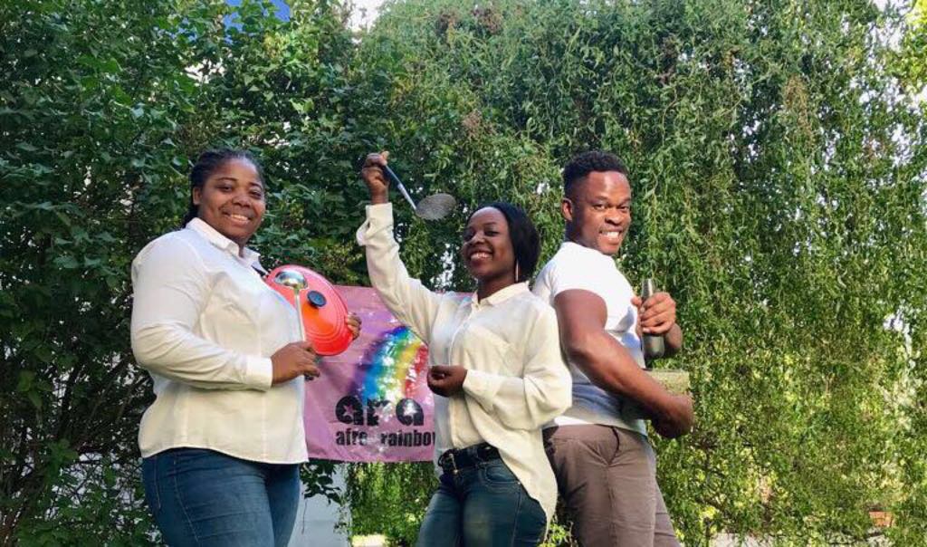 3 members of Afro Rainbow Stop'n Chop holding kitchen utensils